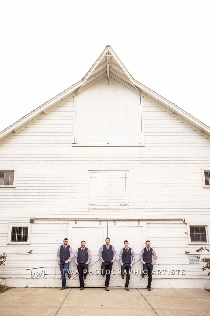 Groomsman Taking a photo at the Danada House Stables, a Wedding Venue in Wheaton, DuPage County